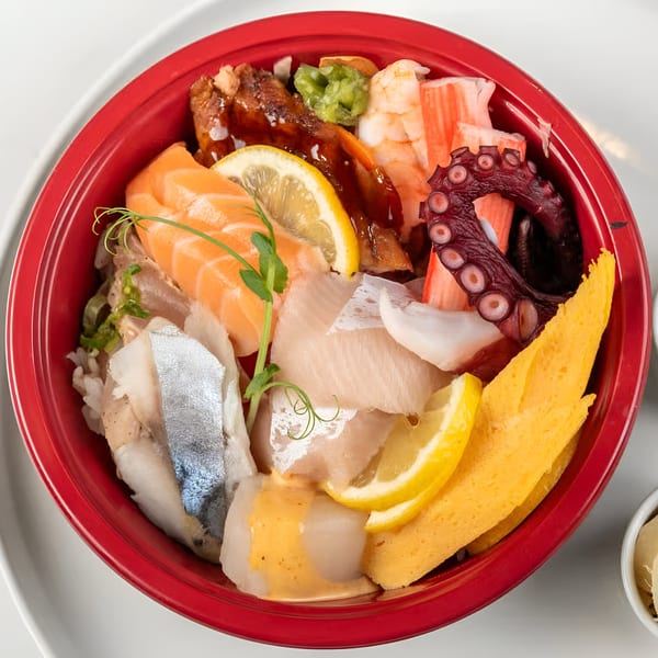 Colorful chirashi bowl from Sushi Totoro with salmon, octopus, eel, shrimp, and tamago.