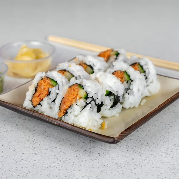Sushi Totoro's spicy tuna rolls with white rice, seaweed, and cucumber, served with ginger and wasabi.